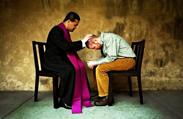 Priest guiding a person for confession